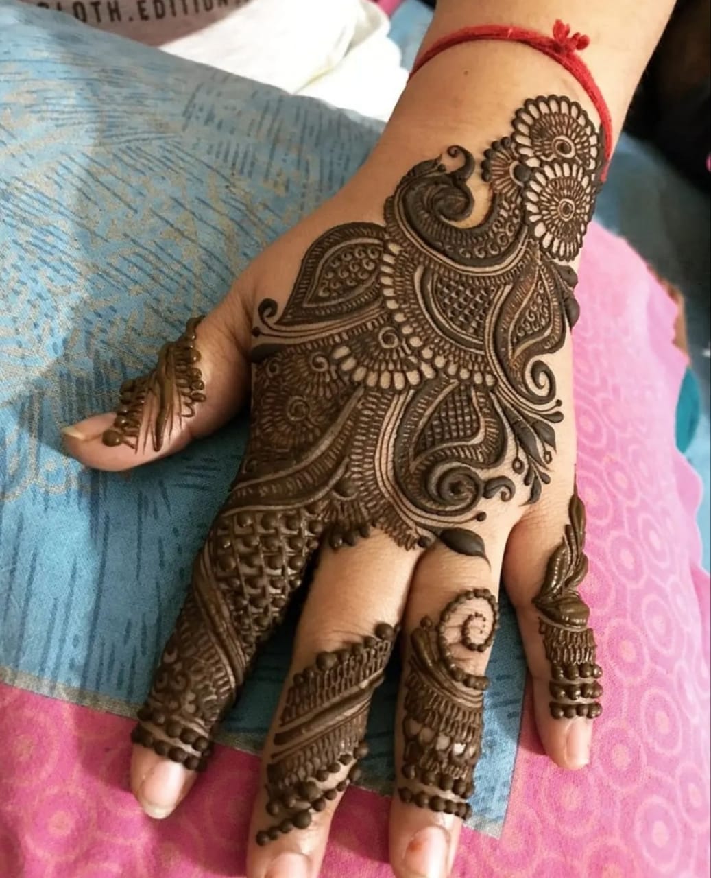 "Customized portrait bridal mehndi showing  bride and groom faces by Mahi Mehndi Artist